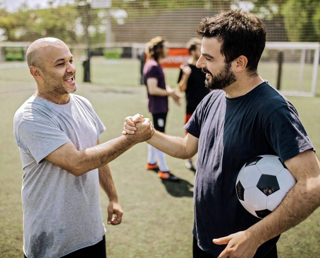 Dos jugadores se saludan en la cancha antes de empezar a jugar.